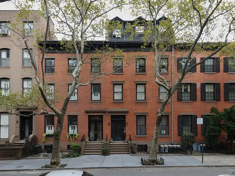 A row of brick and brownstone townhouses on a tree-lined Brooklyn Heights street