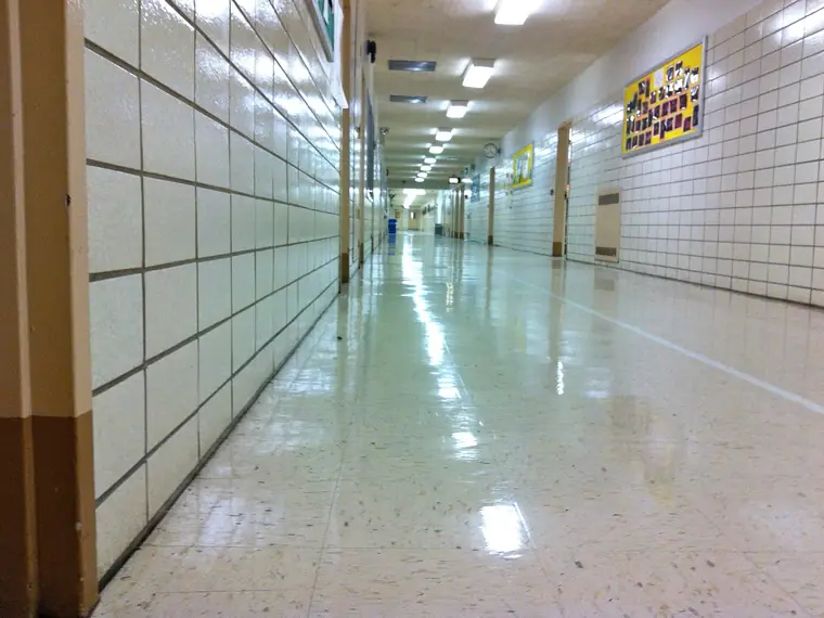 Long school hallway with a shiny tile floor at a Bronx high school